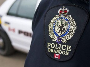 Brandon police emblem with cruiser in background.