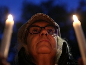 An anti-racism campaigner takes part in a vigil, following the discovery of 39 bodies in a truck container on Wednesday, outside the Home Office in London, Britain Oct. 24, 2019.