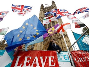 An anti-Brexit protester waves an EU flag outside the Houses of Parliament in London, Britain, October 25, 2019.