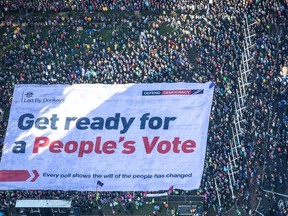 An aerial view shows Brexit accountability campaign group Led By Donkeys unfurling a large crowd banner, as a spoof of the government's advertising campaign, at Parliament Square, London, Britain October 19, 2019.