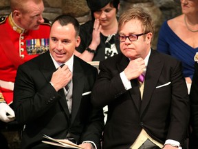 British artist Elton John, right, and his partner David Furnish attend the royal wedding of Britain's Prince William and Kate Middleton, at Westminster Abbey in central London, on April 29, 2011.