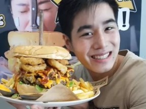 Chris Steaks and Burgers in Bangkok, Thailand is offering a cash prize to anyone who can eat this giant burger in nine minutes. (YouTube)
