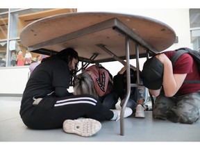 Compton Community College students Alma Angel, 19, (L-R), Jacqueline Parra, 19, Ana Angel, 19, and Hugo Sierra, 18, participate in the Great ShakeOut earthquake drill as California releases its new MyShake early warning app, in Los Angeles, California, October 17, 2019.
