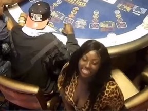 Cops in Florida are searching for this woman seen in a security camera footage, and another suspect who they believe drugged and robbed a poker player. (Broward Sheriff's Office0
