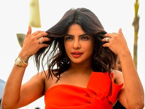 Priyanka Chopra Jonas gestures as she poses for photographs during the promotion of the upcoming biographical Hindi film "The Sky Is Pink" in Mumbai on Sept. 26, 2019.
