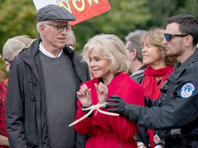 ane Fonda, joined at left by Ted Danson, is arrested at the Capitol for blocking the street after she and other demonstrators called on U.S. Congress for action to address climate change, in Washington, D.C., Friday, Oct. 25, 2019.