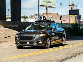 In this file photo taken on September 13, 2016 a pilot model of an Uber self-driving car travels in Pittsburgh. (ANGELO MERENDINO/AFP/Getty Images)