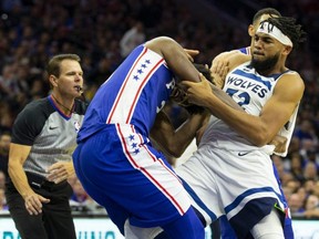 76ers' Joel Embiid, left, fights with Karl-Anthony Towns, right, of the Timberwolves during third quarter NBA action at the Wells Fargo Center in Philadelphia, on Wednesday, Oct. 30, 2019.