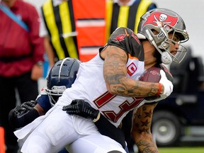 Tampa Bay Buccaneers wide receiver Mike Evans dives for the first down against Tennessee Titans cornerback Logan Ryan during the second half at Nissan Stadium in Nashville, Tenn., on Oct. 27, 2019.