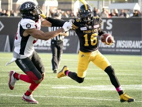 Hamilton Tiger-Cats wide receiver Brandon Banks (16) fends off Ottawa Redblacks linebacker Kevin Brown II (31) during first-half CFL football game action in Hamilton, Ont. on Saturday, Oct. 19, 2019.