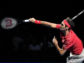 Roger Federer serves a ball to Alex De Minaur during their final match at the Swiss Indoors tennis tournament in Basel on Oct.  27, 2019.
