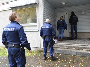 Police enter a student dormitory in Sarkiniemi in Kuopio, Finland, on Oct. 2, 2019, in order to search a suspect's home, one day after he perpetrated a deadly attack in which one person died and 10 people were injured that occurred on the premises of the Savo Vocational College.