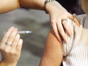 A person gets a flue shot during a flu vaccine program in Calgary in this Oct. 26, 2009 file photo. THE CANADIAN PRESS/Jeff McIntosh
