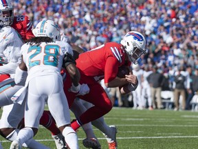 Buffalo Bills quarterback Josh Allen scores on a two point conversion past Miami Dolphins strong safety Bobby McCain during the fourth quarter at New Era Field.