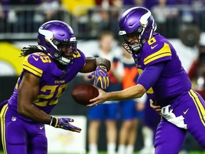 Minnesota Vikings quarterback Kirk Cousins hands the ball off to running back Alexander Mattison in the third quarter against the Washington Redskins at U.S. Bank Stadium.