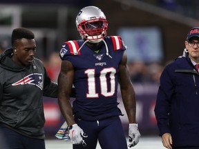 New England Patriots wide receiver Josh Gordon is helped off of the field during the first half against the New York Giants at Gillette Stadium.