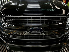 In this file photo taken on Sept. 27, 2018, this photo shows a Ford logo on a front bumper as Ford 2018 and 2019 F-150 trucks sit on the assembly line at the Ford Motor Company's Rouge Complexin Dearborn, Michigan. (JEFF KOWALSKY/AFP via Getty Images)
