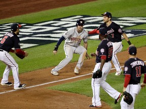 Kyle Tucker of the Houston Astros is caught in a rundown by Trea Turner of the Washington Nationals during the sixth inning in Game 3 of the 2019 World Series at Nationals Park on Oct. 25, 2019 in Washington, D.C.