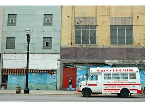 An educational services bus for children sits in front of vacant buildings on Broadway in Gary, Indiana, Thursday, April 20, 2006.