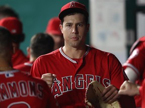 Starting pitcher Tyler Skaggs of the Los Angeles Angels is congratulated by teammates in the dugout after striking out Ryan O'Hearn of the Kansas City Royals for the third out with the bases loaded during the 4th inning of the game at Kauffman Stadium on April 26, 2019 in Kansas City, Miss.