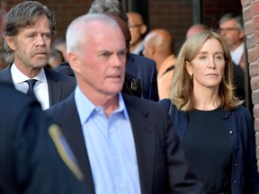 Felicity Huffman and husband William Macy exit John Moakley U.S. Courthouse where Huffman received a 14 day sentence for her role in the college admissions scandal on Sept. 13, 2019 in Boston, Mass.  (Paul Marotta/Getty Images)