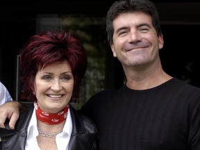 Sharon Osbourne and Simon Cowell pose for photos after auditioning hundreds of hopeful musicians for their new TV show "X Factor" at Jury's Hotel, Dublin, Ireland, July 6, 2004.  (ShowBizIreland/Getty Images)