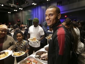 Andre De Grasse, hosts families from the Regent Park neighbourhood for a lunch on Thanksgiving Monday. (Stan Behal/Toronto Sun)