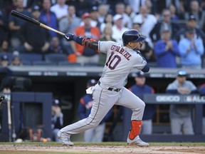 Houston Astros first baseman Yuli Gurriel hits an infield singleagainst the New York Yankees during the first inning of Game 3 of the ALCS on Tuesday. (Brad Penner/USA TODAY Sports)