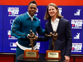 Milwaukee Brewers Josh Hader, right, and New York Yankees Aroldis Chapman pose with their reliever of the year trophies at a news conference before Game 4 of the baseball World Series between the Houston Astros and the Washington Nationals Saturday, Oct. 26, 2019, in Washington.
