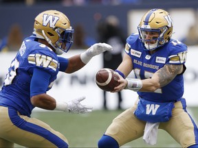 Blue Bombers’ Andrew Harris (left) takes a hand-off from quarterback Chris Streveler during the first half against the Montreal Alouettes on Saturday in Winnipeg.  (JOHN WOODS/THE CANADIAN PRESS)
