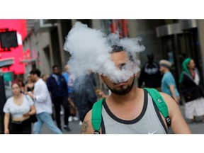 A man uses a vape as he walks on Broadway in New York City, U.S., September 9, 2019.