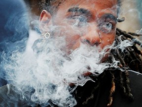 A demonstrator vapes during a protest at the Massachusetts State House against the state's four-month ban of all vaping product sales in Boston, Massachusetts, U.S., October 3, 2019.