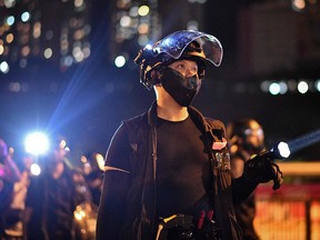 Riot police shine lights at protesters outside Ma On Shan police station in Hong Kong on October 9, 2019. (Anthony WALLACE / AFP)