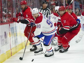 Canadiens forward Tomas Tatar, 90, and Hurricanes centre Jordan Staal, 11, chase the puck during first-period action at PNC Arena in Raleigh, N.C.