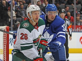 Maple Leafs' Justin Holl (right) is eager to get into the lineup against the Boston Bruins on Saturday. (GETTY IMAGES)