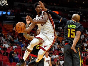Miami Heat forward Jimmy Butler, left, looks to pass the ball as Atlanta Hawks guard Vince Carter defends during the second half at American Airlines Arena in Miami, Oct. 14, 2019. (Steve Mitchell-USA TODAY)