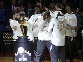 Raptors players take part in the ring ceremony and banner-raising prior their season opener at Scotiabank Arena on Monday night. (Jack Boland/Toronto Sun)