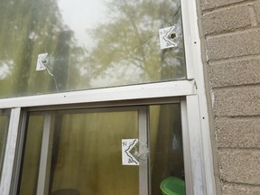 Three bullets are seen in the kitchen window of a townhouse unit Wednesday, Oct. 9, 2019 a day after a double fatal shooting on Grandravine in Toronto.