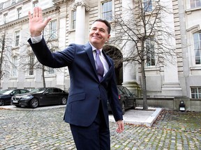 Irish Finance Minister Paschal Donohoe gestures as he emerges from his office for a photo call prior to presenting his budget to parliament, at Government Buildings in Dublin on October 8, 2019. (PAUL FAITH/AFP via Getty Images)