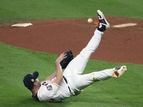 Astros pitcher Justin Verlander throws the ball off his leg after fielding an infield single hit by Nationals' Ryan Zimmerman (not pictured) during 4th inning action in Game 2 of the 2019 World Series at Minute Maid Park in Houston, on Wednesday, Oct. 23, 2019.