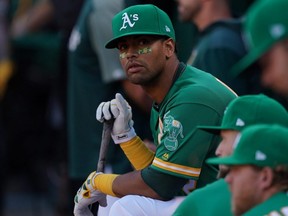 Athletics' Khris Davis looks on from the dugout during the American League Wild Card Game against the Rays at RingCentral Coliseum in Oakland, Calif., on Oct. 2, 2019.