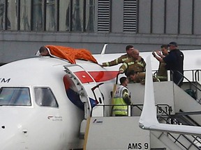 A protester, who Extinction Rebellion says is former Paralympic athlete James Brown, lies on top of a British Airways plane at London City Airport, in London, October 10, 2019. (REUTERS/Henry Nicholls)