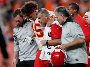 Quarterback Patrick Mahomes of the Kansas City Chiefs is escorted off the field after an injury in the first half against the Denver Broncos at Broncos Stadium at Mile High on October 17, 2019 in Denver. (Matthew Stockman/Getty Images)