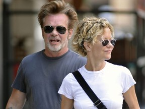 Meg Ryan carries some drinks while out for a stroll in Manhattan with John Mellencamp  in this June 2013 file photo. (TNYF/WENN.com)