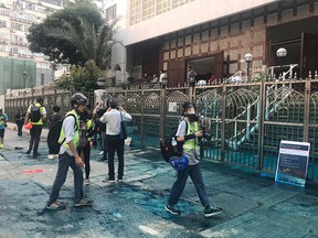 Members of the press are seen outside the Kowloon Masjid and Islamic Centre in Hong Kong, after police doused it with a water cannon, on October 20, 2019 in this picture obtained from social media. (Jeremy Tam/Civic Party via REUTERS)