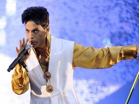 US singer and musician Prince (born Prince Rogers Nelson) performs on stage at the Stade de France in Saint-Denis, outside Paris, on June 30, 2011.