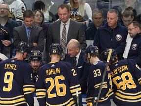 Sabres head coach Ralph Krueger (centre) discusses power play options with Jack Eichel (9), Rasmus Dahlin (26), Colin Miller (33), and Victor Olofsson (68), late in the third period at KeyBank Center in Buffalo, N.Y., on Oct. 9, 2019.