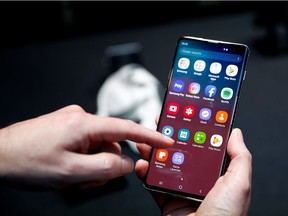 A journalist uses the new Samsung Galaxy S10 smartphone at a press event in London, Britain February 20, 2019.