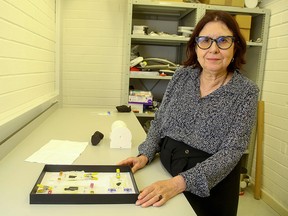 Francoise Berard, Director of the Library at the Institute de France, poses for a photograph with a box containing fragments of Herculaneum scrolls, at Diamond Light Source in Didcot, west of London on Sept. 30, 2019.