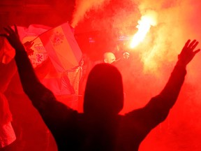 Protesters hold Spanish flags and light flares during a pro-union demonstration called by far-right collectives in Barcelona on October 17, 2019. (PAU BARRENA/AFP via Getty Images)